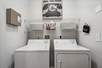 two washers and two sinks in a laundry room